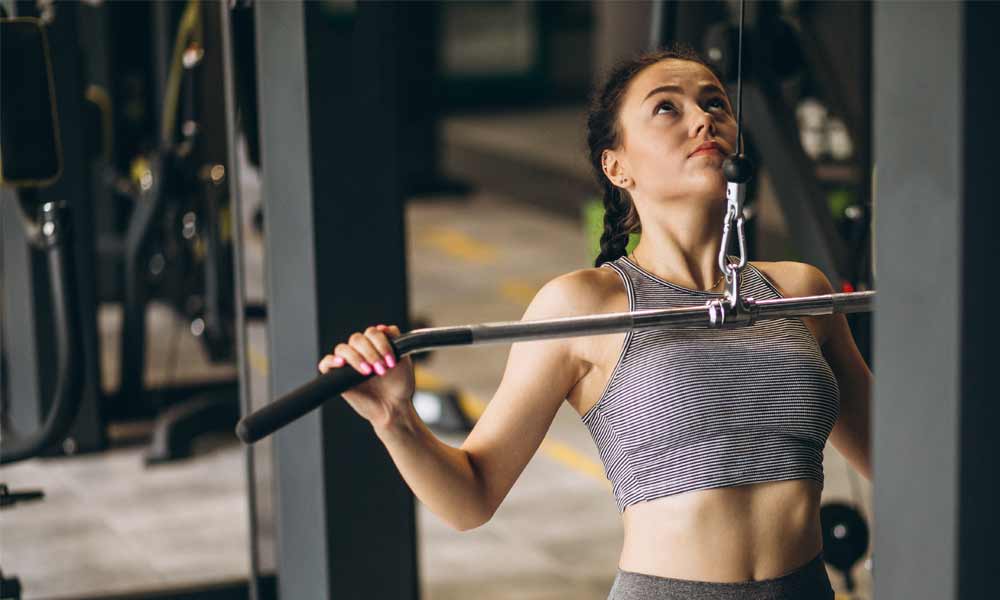 Woman doing lat pulldowns at a gym near Clearwater, FL